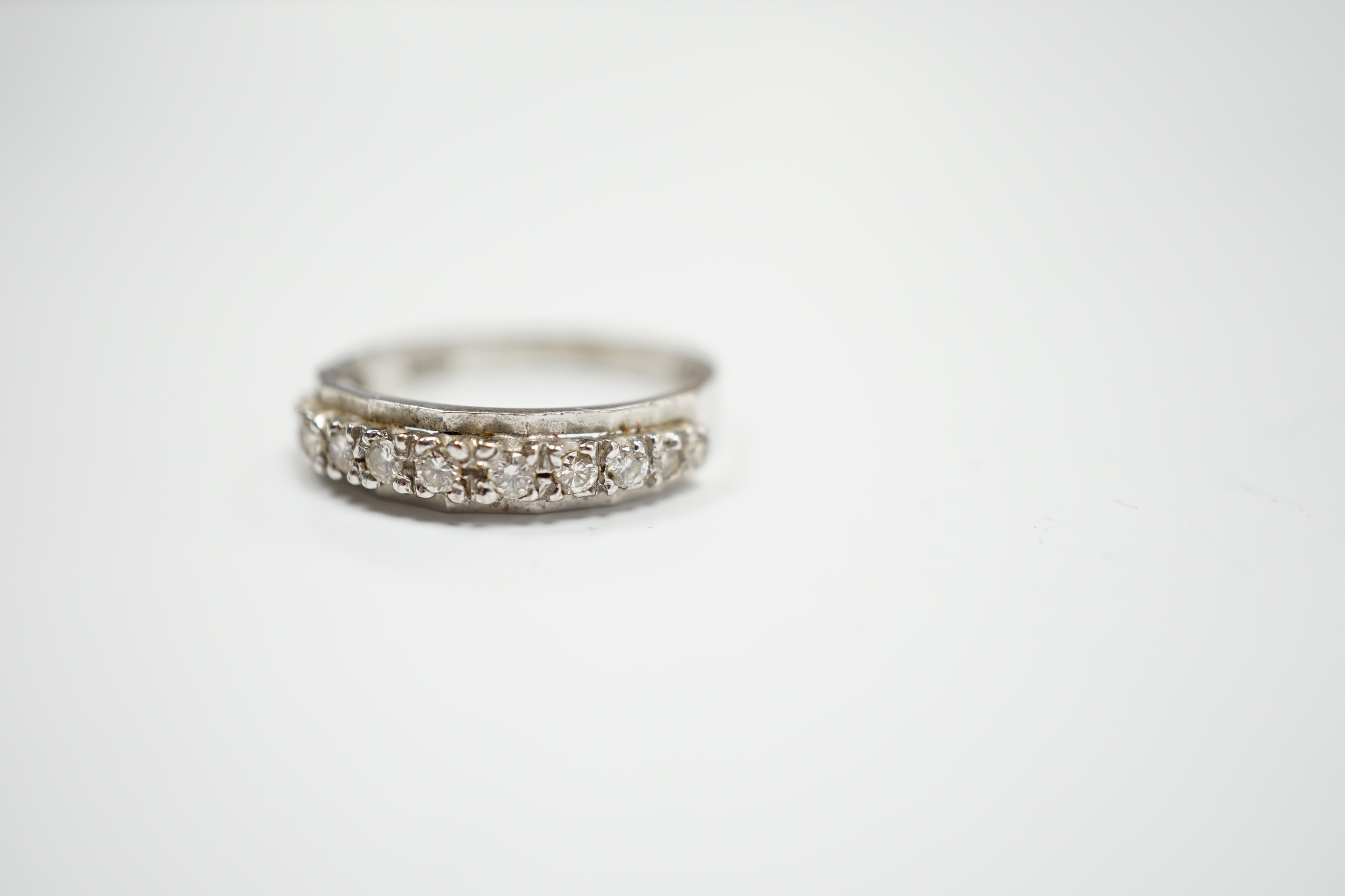 An 18ct white gold and diamond chip set half eternity ring, size M, gross weight 2.8 grams.